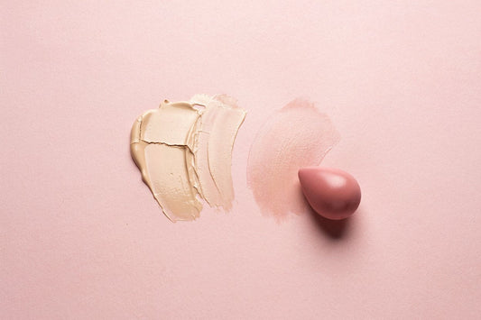 Cakey, cracked foundation swatch next to a smoothly blended swatch and a makeup sponge